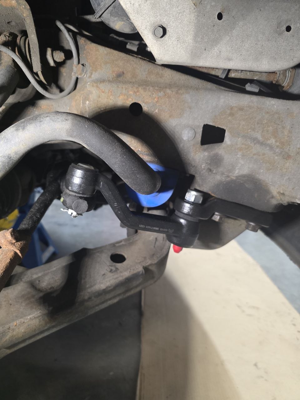 Stabilizer bar link and bushings on a vehicle raised for suspension work